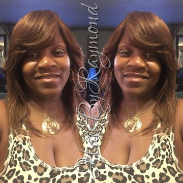 A woman with styled hair smiles in a mirrored photo effect.