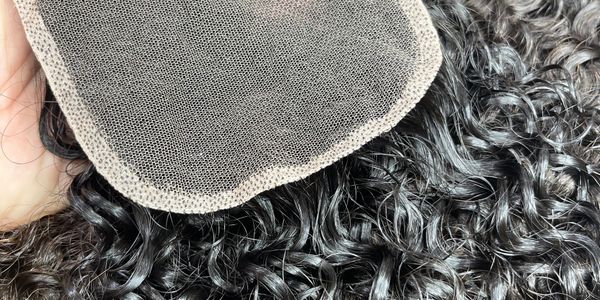 Close-up of curly hair with a lace closure piece.