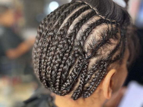 Close-up of neatly braided hair styled in cornrows.