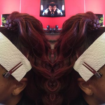 Woman with braided hair and a paper towel on her head, mirrored image.