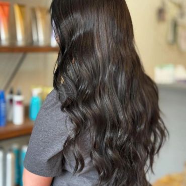 Long, wavy dark brown hair viewed from behind.