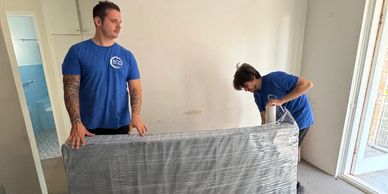 Removalist wrapping mattress in shrink wrap