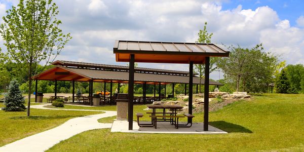 Picnic area with shelters in a park.