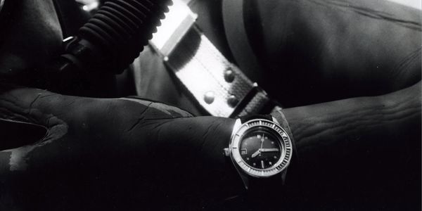 Vintage picture of a vintage Squale dive watch on wrist of a diver