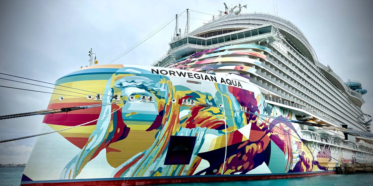 The Norwegian Aqua cruise ship docked with vibrant hull art.