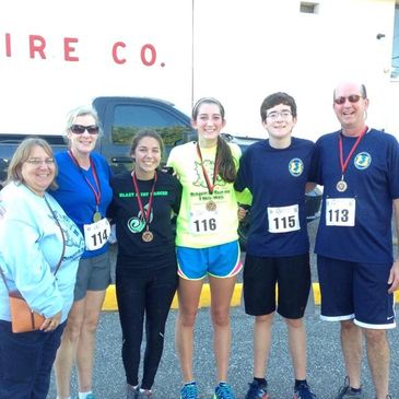 Dragon Run Race Founder and Nate's mom, Lauren Boerlin pictured with  President Coughlan and race pa