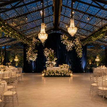 Elegant wedding venue with starry ceiling and floral decorations.