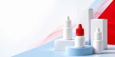 Eyedrop bottles with boxes on blue and white surface.