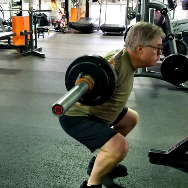 Client squatting at the gym