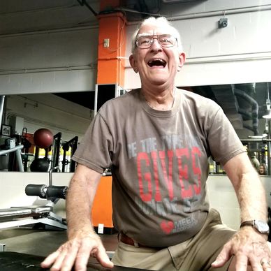 Senior client smiling during workout