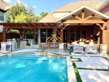 Cedar cover and cedar arbor over patio and stone kitchen