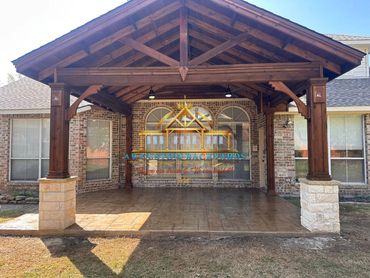 Ceadr patio cover with tan stamped concrete