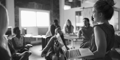 Woman giving a presentation in an office setting.