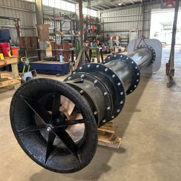 Large mechanical fan or turbine in an industrial workshop.