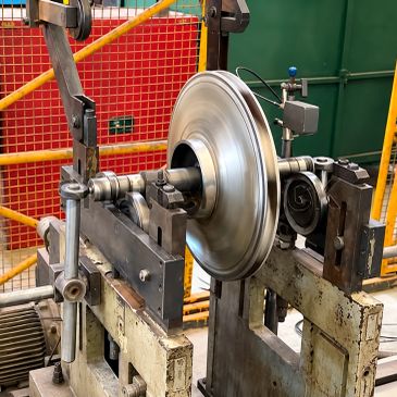 Metalworking lathe machine with spinning metal part.