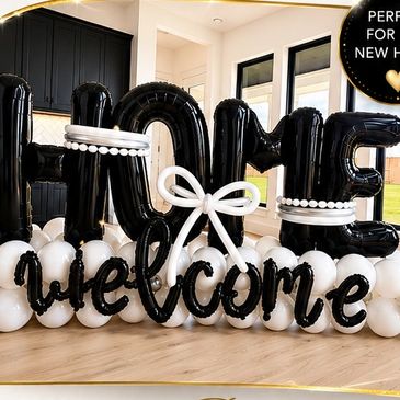Black and white balloon arrangement saying "Home welcome."