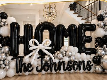 Black and white balloon arrangement saying "Home welcome."