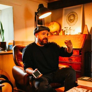 Man talking in a sitting room.