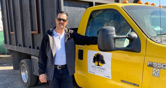 A man posing next to a truck