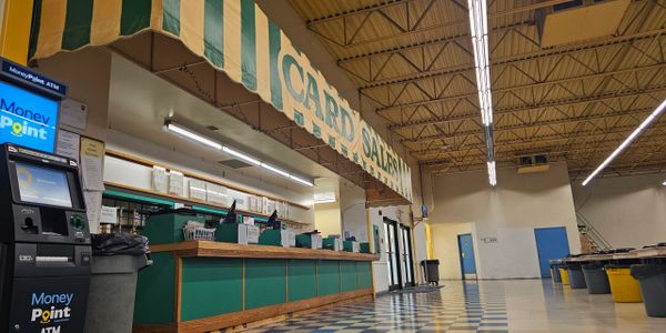 Indoor card sales counter with ATM and check cashing services.