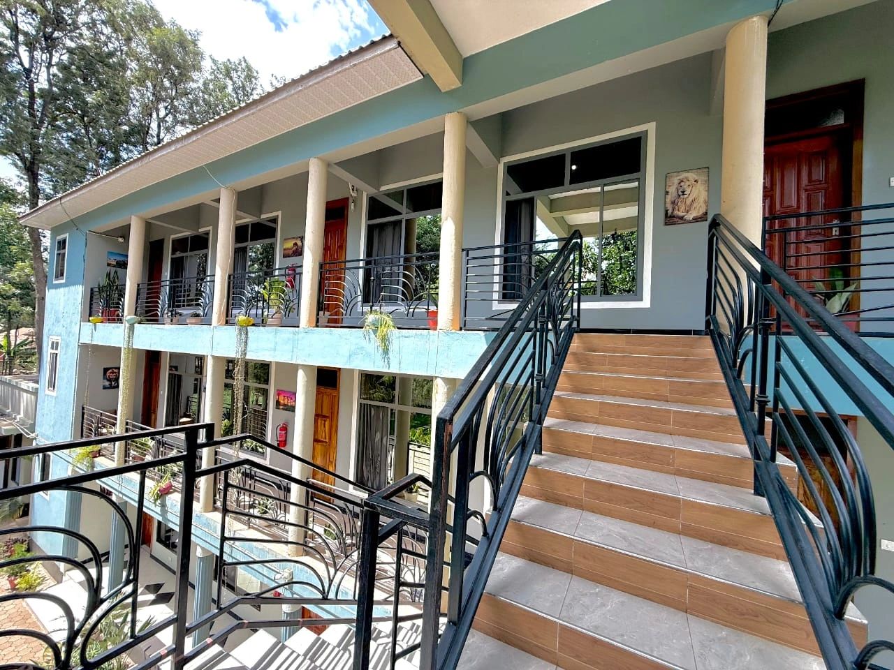 Modern two-story building with stairs and balcony railings.