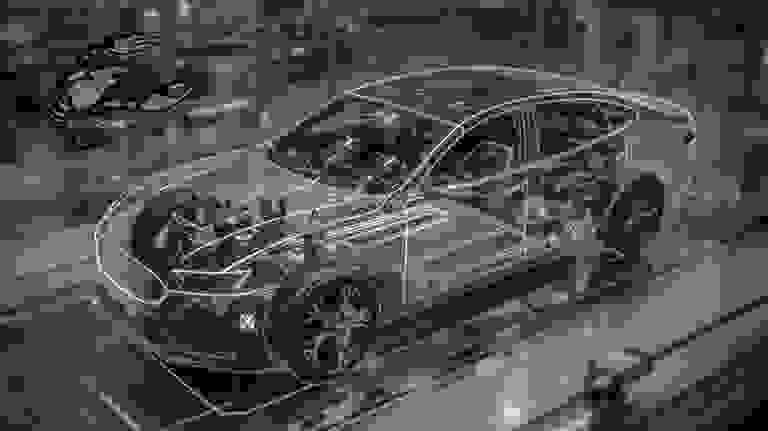 Stack of books next to pencils in a holder and a camera.