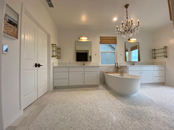 Spacious modern bathroom with a freestanding tub and dual vanities.
