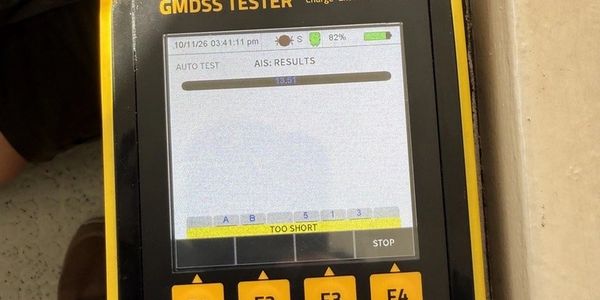 GMDSS tester running an AIS check aboard a cargo ship in Freeport, Bahamas