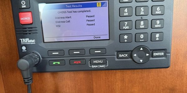 GMDSS distress alert test results showing passed on a yacht's satellite terminal