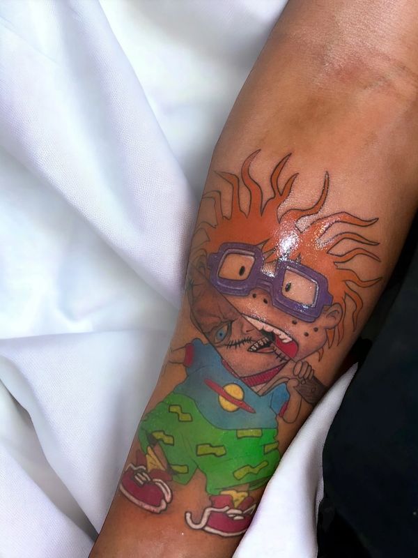 Chucky vs Chuckie color arm tattoo on brown skin