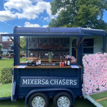 Outdoor mobile drink bar named Mixers &amp; Chasers.