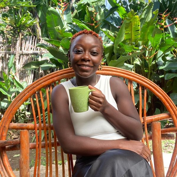 Black women smiling with a cup of tea