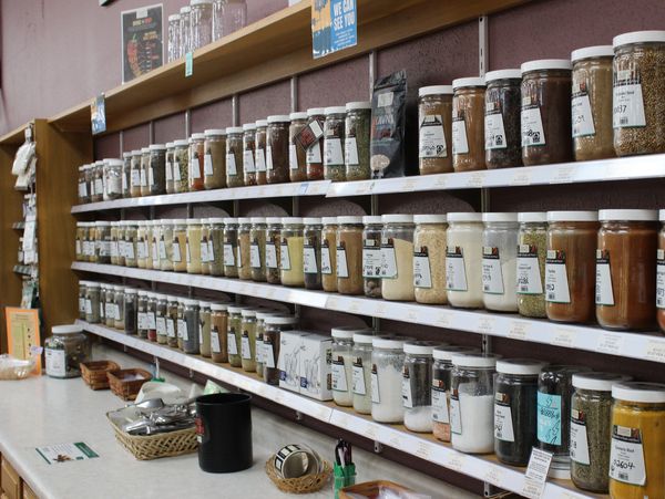 Shelves filled with jars of various spices and ingredients.