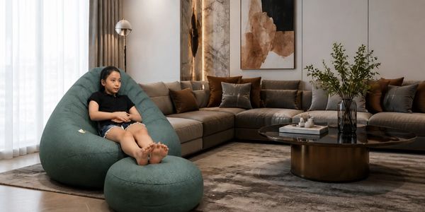 A girl relaxing on a green bean bag chair in a modern living room.