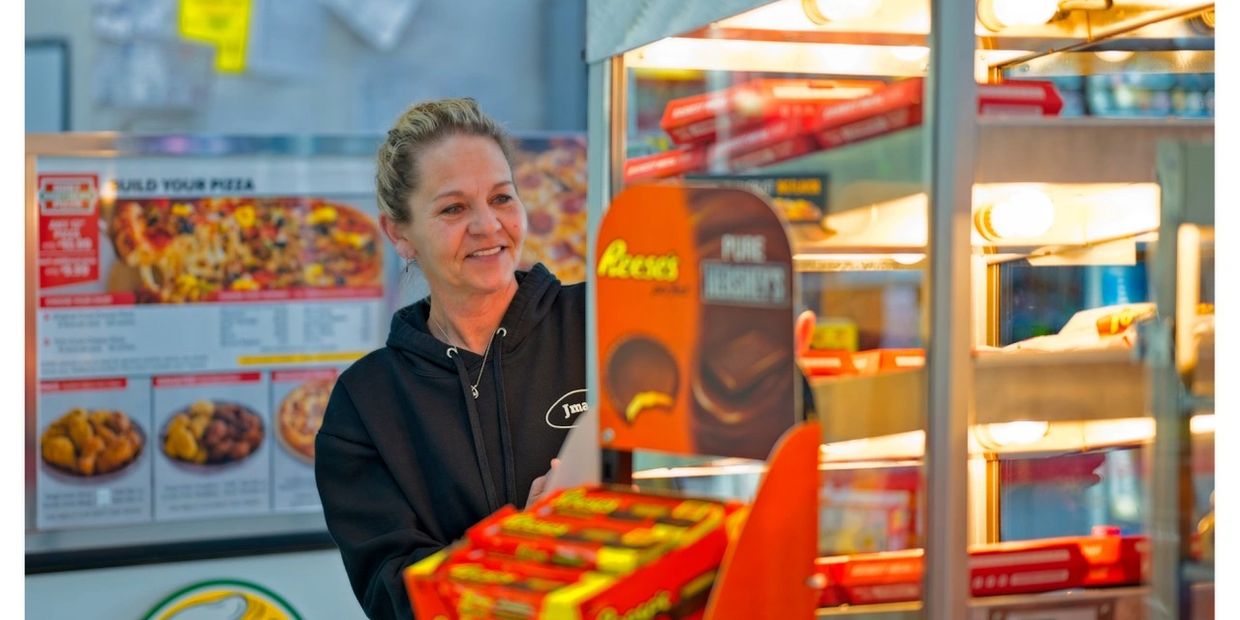 Women filling up pizza display