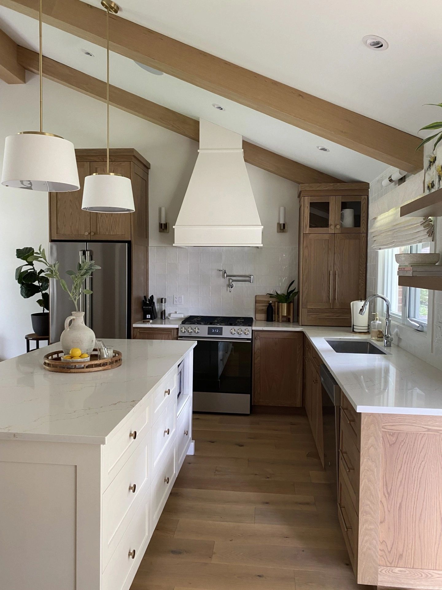 Modern kitchen with wooden cabinets and white countertops.