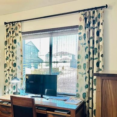 Cozy home office with wooden furniture and a window.