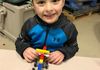 Super Lou putting together a LEGO car at Cub Scouts winter camp.