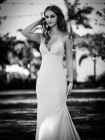 Prom portrait young woman curly hair in black and white.