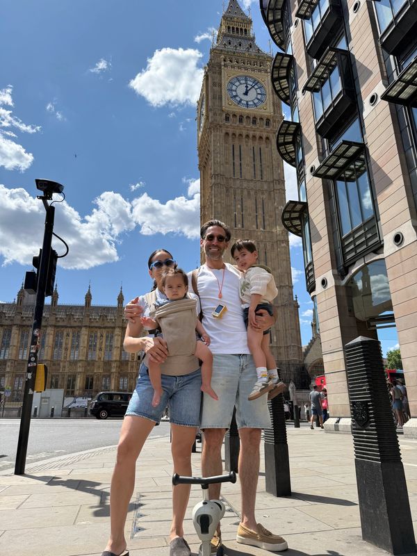 Family posing near Big Ben on a sunny day.