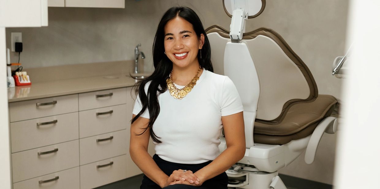 Smiling woman sitting in a dental office chair.