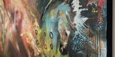Abstract painting of horses with vibrant colors and dynamic brushstrokes.