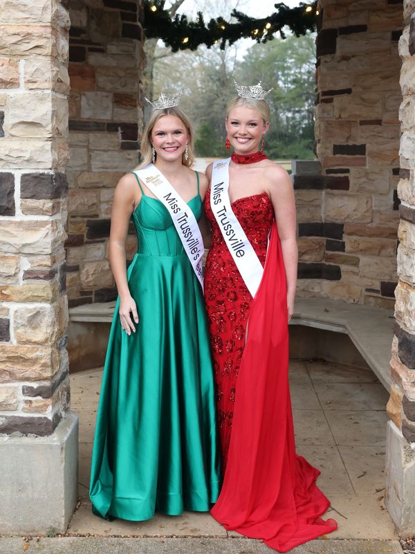 Two crowned Miss Trussville pageant winners in elegant evening gowns.