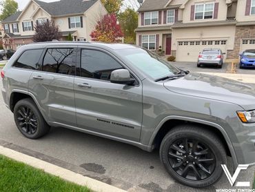 a gray car with dark window tint