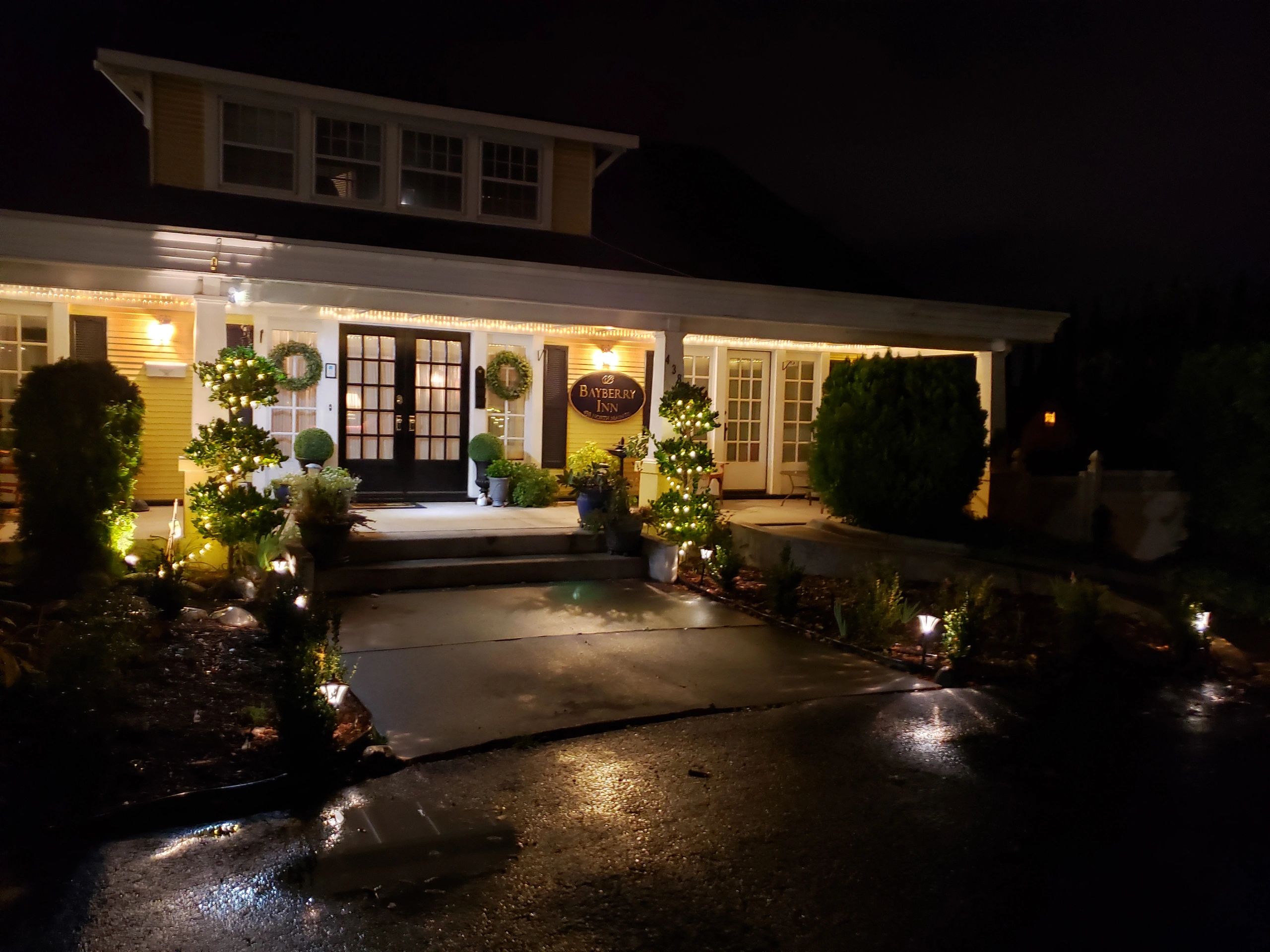 A house with a porch and lights at night