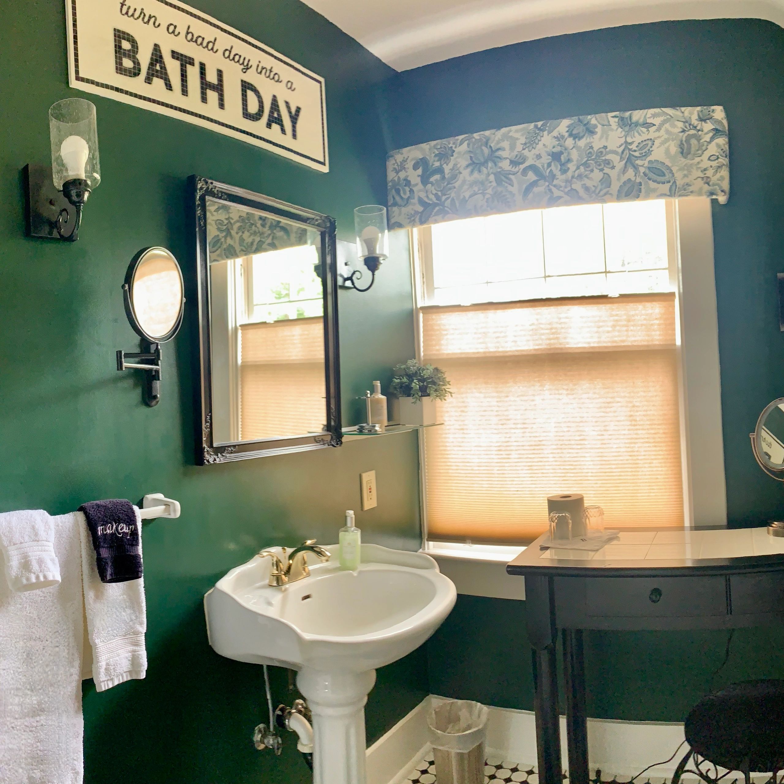 a bathroom with a green wall and a white sink