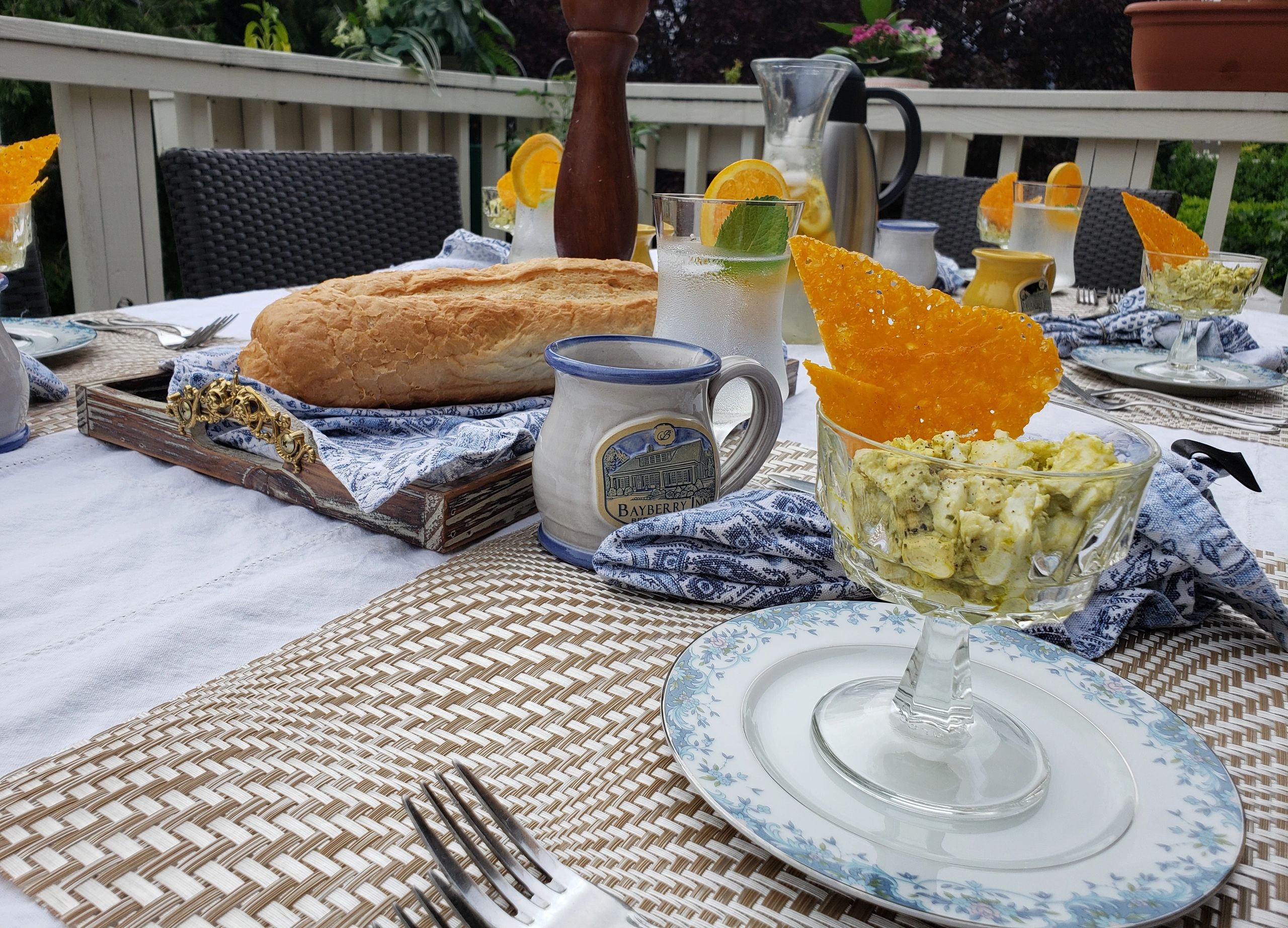 a table set with food and dishes on an outdoor patio