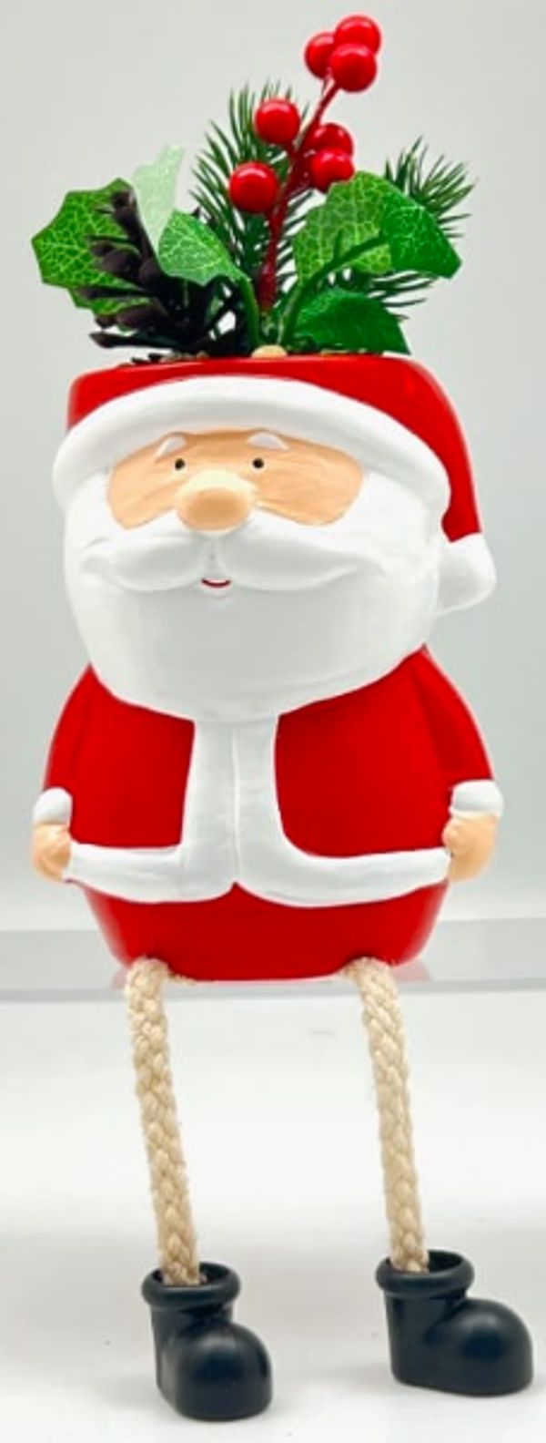 Cute Santa planter with festive greenery and berries.