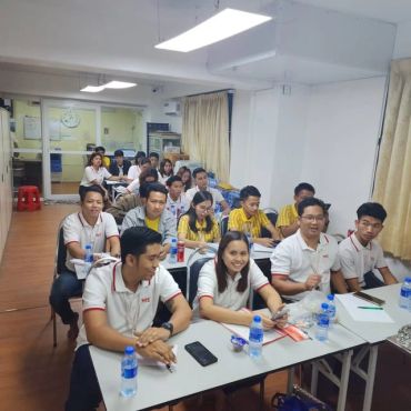 Group of people in a classroom setting.