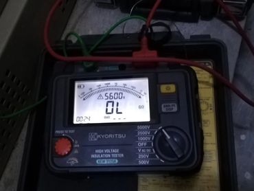 Kyoritsu high voltage insulation tester with test leads connected.